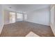 Bright, open living room with neutral carpeting, white walls, and an open view of the kitchen at 473 Elm Crest Pl, Henderson, NV 89012