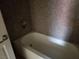Clean white bathtub in bathroom with tiled walls and a showerhead fixture at 4965 Indian River Dr # 108, Las Vegas, NV 89103