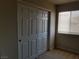 Neutral bedroom featuring a closet with sliding panel doors and window with closed blinds at 4965 Indian River Dr # 108, Las Vegas, NV 89103