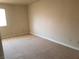 Neutral bedroom with plush carpet, and bright natural light from a large window at 4965 Indian River Dr # 108, Las Vegas, NV 89103