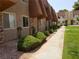 Exterior community view showing manicured lawns, bushes, and walkways to the building at 4965 Indian River Dr # 108, Las Vegas, NV 89103