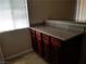 Kitchen area featuring dark cabinets and neutral granite countertop at 4965 Indian River Dr # 108, Las Vegas, NV 89103