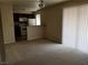 Bright living room with neutral carpet, and natural light from a large window at 4965 Indian River Dr # 108, Las Vegas, NV 89103
