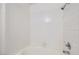 Bright tub and shower with white tile from floor to ceiling and chrome fixtures at 5000 Red Rock St # 105, Las Vegas, NV 89118