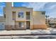 A tan two-story condo with a small balcony and a sidewalk leading to the front door at 5000 Red Rock St # 105, Las Vegas, NV 89118
