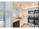 Well-lit kitchen with stainless steel appliances, white cabinetry, and double bowl sink at 5000 Red Rock St # 105, Las Vegas, NV 89118