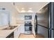 Modern kitchen featuring white cabinets, stainless steel appliances, and tile flooring at 5000 Red Rock St # 105, Las Vegas, NV 89118