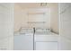 Laundry room with side by side washer and dryer and two shelves for storage at 5000 Red Rock St # 105, Las Vegas, NV 89118