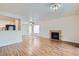 Spacious living room with fireplace, wood-look flooring, and view of front entrance at 5000 Red Rock St # 105, Las Vegas, NV 89118