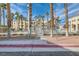 Community pool area with palm trees and gated access in the neighborhood at 5000 Red Rock St # 105, Las Vegas, NV 89118