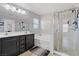 A luxurious bathroom with a double vanity, a soaking tub, and a glass-enclosed shower at 5009 Rustic Charm Ct, Las Vegas, NV 89131