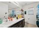 This bathroom has double vanity with black cabinets at 5009 Rustic Charm Ct, Las Vegas, NV 89131