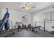 Exercise room with rubber flooring, weights, ceiling fan, and natural light from windows at 5009 Rustic Charm Ct, Las Vegas, NV 89131