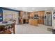 Open kitchen featuring wood cabinets, stainless steel appliances, an island, and adjacent dining area at 5009 Rustic Charm Ct, Las Vegas, NV 89131