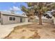 A spacious backyard with a large tree and concrete patio at 5439 Pomeroy Cir, Las Vegas, NV 89142