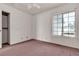 Bedroom with pink carpet, ceiling fan and a large window at 5439 Pomeroy Cir, Las Vegas, NV 89142