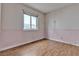 Bedroom with hardwood floors, pink walls and wallpaper at 5439 Pomeroy Cir, Las Vegas, NV 89142
