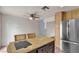 Dining area features an island with barstool seating and a stainless steel refrigerator at 5439 Pomeroy Cir, Las Vegas, NV 89142