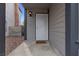 Close up of the entrance, featuring a white security door, a light fixture, and gray trim at 5439 Pomeroy Cir, Las Vegas, NV 89142