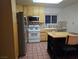 Classic kitchen featuring light wood cabinets, stainless steel appliances, and a cozy breakfast bar at 5439 Pomeroy Cir, Las Vegas, NV 89142