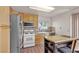 Kitchen featuring oak cabinets, stainless steel refrigerator, and a small island with barstool seating at 5439 Pomeroy Cir, Las Vegas, NV 89142