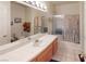 Bright bathroom featuring a single sink vanity, tiled countertops, and shower-tub combo at 5449 Bugle Way # 102, Las Vegas, NV 89108