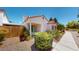 Charming single-story home with a landscaped front yard and a concrete pathway leading to the entrance at 5449 Bugle Way # 102, Las Vegas, NV 89108