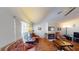 Bright living room featuring hardwood floors, comfortable seating, fireplace, ceiling fan, and natural light at 5449 Bugle Way # 102, Las Vegas, NV 89108