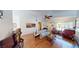 Bright living room featuring hardwood floors, comfortable seating, natural light, and artistic decorations at 5449 Bugle Way # 102, Las Vegas, NV 89108
