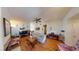 Open living room featuring hardwood floors, comfortable seating, access to dining area, and fireplace at 5449 Bugle Way # 102, Las Vegas, NV 89108