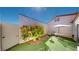 Private patio with artificial grass, a BBQ grill, and outdoor seating area at 5449 Bugle Way # 102, Las Vegas, NV 89108