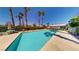 Resort-style pool with crystal-clear water, palm trees, and ample lounging space at 5449 Bugle Way # 102, Las Vegas, NV 89108