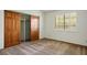 This bedroom features wood closet doors and a window with white blinds at 5505 Indian Hills Ave, Las Vegas, NV 89130