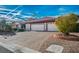 A well-maintained home featuring a three-car garage and brick driveway at 5505 Indian Hills Ave, Las Vegas, NV 89130