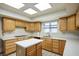 Well-lit kitchen with stainless steel appliances, tile floors and matching backsplash at 5505 Indian Hills Ave, Las Vegas, NV 89130