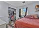 Comfortable bedroom with a large window, closet storage, and cozy decor at 5731 Kona Mountain St, North Las Vegas, NV 89031