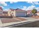 Single-story home featuring a two-car garage, tile roof, and desert landscaping for low maintenance at 5731 Kona Mountain St, North Las Vegas, NV 89031