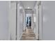 Bright hallway with multiple doorways and wood-look flooring, providing access to various rooms at 5731 Kona Mountain St, North Las Vegas, NV 89031