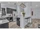 Modern kitchen with stainless steel appliances, dark cabinetry, and breakfast bar at 5731 Kona Mountain St, North Las Vegas, NV 89031