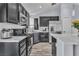 Well-equipped kitchen with stainless steel appliances, dark cabinets, and white countertops at 5731 Kona Mountain St, North Las Vegas, NV 89031