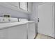 Efficient laundry room with modern appliances and cabinet storage space at 5731 Kona Mountain St, North Las Vegas, NV 89031