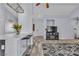 Open-concept living space with breakfast bar, modern countertops, and seamless flow to the living area at 5731 Kona Mountain St, North Las Vegas, NV 89031