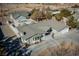 Aerial view of home with spacious driveway, bay window, fenced backyard, and mature trees at 714 Lacy Ln, Las Vegas, NV 89107