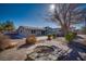 Backyard view of a home with patio and fire pit surrounded by lush greenery on a sunny day at 714 Lacy Ln, Las Vegas, NV 89107