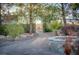 Backyard featuring a curved stone paver walkway, stone fire pit, and lush landscaping at 714 Lacy Ln, Las Vegas, NV 89107
