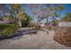 Landscaped backyard featuring mature trees and shrubs, and a stone fire pit at 714 Lacy Ln, Las Vegas, NV 89107