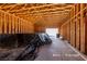 Unfinished barn or storage space with exposed wood framing and concrete flooring offering potential for customization at 714 Lacy Ln, Las Vegas, NV 89107