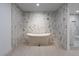 Beautiful soaking tub situated in a luxurious bathroom with unique tile design and sleek fixtures at 714 Lacy Ln, Las Vegas, NV 89107