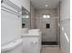 Bathroom features a vessel sink, a modern walk-in shower with gray tile, and towel racks at 714 Lacy Ln, Las Vegas, NV 89107