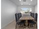 Spacious dining room featuring a rustic table with seating for eight under recessed lighting and a large window at 714 Lacy Ln, Las Vegas, NV 89107